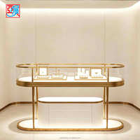 Table de présentation de bijoux ovale de luxe à deux niveaux, support personnalisé en verre avec cadre doré pour bagues et colliers, idéal pour les bijouteries