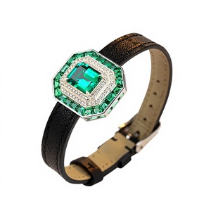 Pulsera de lujo para mujer con diamantes de corte octogonal, piedras laterales de esmeralda y diamantes cultivados en laboratorio sobre una correa de cuero negro. - Product Image 1
