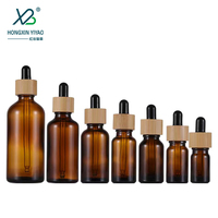 Bouteilles en verre en gros de 10 ml, 30 ml, 100 ml avec couvercles en bambou pour crème visage, gouttes pour les yeux, huile essentielle, mascara, compte-gouttes sérigraphié