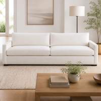 Canapé modulaire moderne ultra long en velours gris clair avec accoudoirs bas et doubles coussins, idéal pour appartement et hôtel