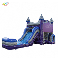 Château gonflable commercial avec toboggan et piscine pour enfants, idéal pour les fêtes en plein air