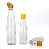 Bouteille cylindrique en verre transparent en gros avec bec verseur en plastique pour l'emballage d'huile d'olive, de vinaigre, de sauces et d'assaisonnements