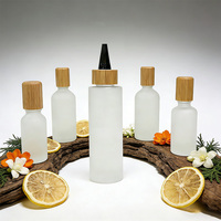Bouteilles compressibles en verre dépoli personnalisées en gros avec bouchon en bambou, pots vides anti-fuite pour huile capillaire, sérum pour le cuir chevelu et produits de soin de la peau
