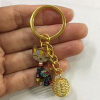 NOUVELLE ARRIVÉE Porte-clés tendance en alliage plaqué or avec breloque chat mignon et support de pièce de monnaie en cage, 25 mm, pour décoration de sac