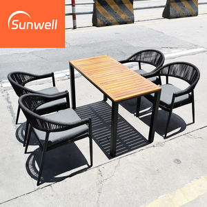 Set da Pranzo Moderno di Alta Qualità per Esterni, <span class=keywords><strong>Giardino</strong></span> e Ristorante, <span class=keywords><strong>Tavolo</strong></span> Quadrato in Legno con <span class=keywords><strong>Sedie</strong></span> Impilabili in Corda e Telaio in Alluminio per Hotel - Product Image 1