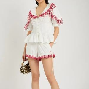 Conjunto Casual de Algodón para Mujer, Estilo Nuevo 2025, Top con Peplum Bordado y Pantalones Cortos con Decoración de Botones, Venta Caliente OEM - Product Image 1