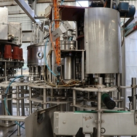 Chaîne de remplissage à chaud 4-en-1 d'occasion avec rinçage, remplissage, capsulage et étiquetage intégrés pour jus de fruits