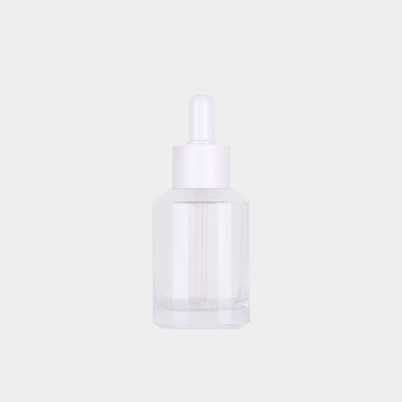 Flacon transparent avec tête en caoutchouc blanc