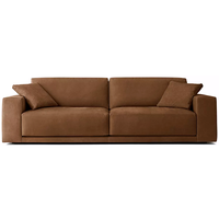 Canapé d'angle en cuir au design tendance en forme de L, avec accoudoirs larges et coussins moelleux pour salon
