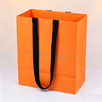 Sac en papier de luxe grande capacité pour vêtements et snacks, avec poignée en ruban orange personnalisée et votre propre logo