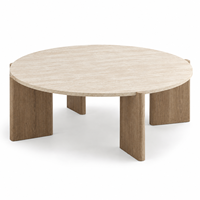 Table basse ronde au look travertin moderne avec pieds larges pour salon