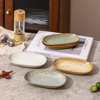 Assiette ovale en céramique émaillée haut de gamme japonaise, résistante au micro-ondes, motif uni, pour restaurant commercial, idéale pour l'export.