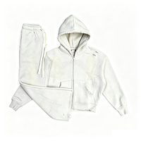 Ensemble survêtement homme oversize déchiré avec logo personnalisé : sweat à capuche zippé à écussons étoiles délavés et pantalon de jogging évasé à bords bruts – Vente en gros