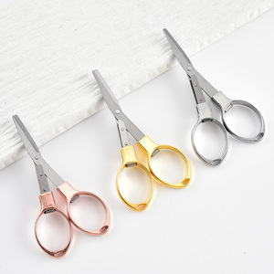 Tijeras Plegables de Viaje Creativas, Mini Tijeras Portátiles de Acero Inoxidable para el Hogar, Corte en Forma de Ocho, Herramientas de Bricolaje, Color Amarillo - Product Image 1