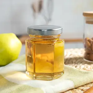 Pots de miel en verre hexagonal 4oz les plus populaires avec couvercles dorés pour breloques d'abeilles et jute