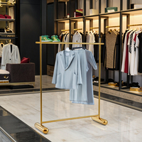 Étagère de présentation de vêtements pliable, design moderne en acier inoxydable, placage or, design élégant pour magasin de détail