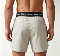 Shorts de sport pour hommes OEM en polyester écoresponsable et élasthanne 160 GSM, certifiés CE Intertek, avec entrejambe de 5 pouces, ourlet fendu et séchage rapide