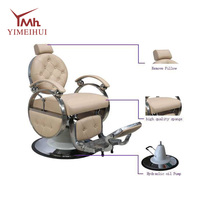 Fauteuil de barbier inclinable robuste de style rétro, en cuir capitonné beige, avec structure en métal poli, rotation à 360°