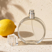 Flacon de parfum élégant, forme plate et ronde, flacon en verre pour parfum avec bouchon transparent de luxe, flacon pulvérisateur de parfum en verre de 100 ml