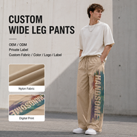 Pantalon de survêtement personnalisé pour homme, bleu et orange contrastés, en nylon léger, coupe large, avec ourlet réglable à cordon, pantalon de sport athlétique