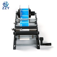 Machine d'étiquetage manuelle ZZY pour bouteilles d'eau rondes en plastique PET PVC, cosmétiques, vin, boîtes de conserve