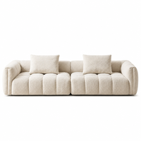 Canapé modulaire Urban Skyline moderne en bouclette crème, garni d'éponge, capitonné, profil bas, idéal pour les salons d'appartements en immeubles de grande hauteur