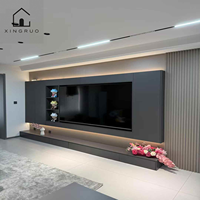 Meuble TV mural moderne noir personnalisé XINGRUO avec éclairage LED, rangement intégré, console multimédia et étagères de présentation