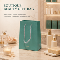 Sac cadeau en papier bleu sarcelle personnalisé avec poignées en corde torsadée et pelliculage mat pour l'emballage de cosmétiques, de parfums et de produits de spa