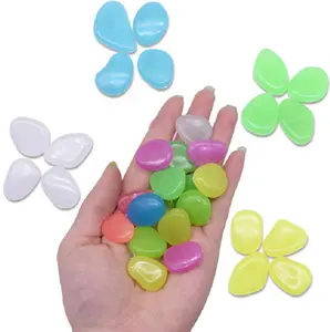 Colorful plastic decorative luminous stones glowing in the dark garden pebbles