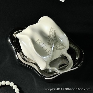 Taza de cerámica con diseño de mariposa, color blanco lechoso y plateado, con platillo para té, café y otras bebidas. - Product Image 5