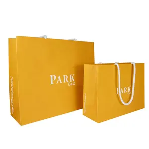 Custom Printed Yellow Carry Bags Luxury Boutique Clothes Retail Shopping Paper Packaging Bags For Clothes With Your Own Logo