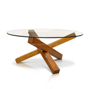 Elegante mesa de centro redonda con patas cruzadas de madera de teca maciza y una elegante superficie de vidrio, que combina durabilidad con un diseño moderno. - Product Image 1
