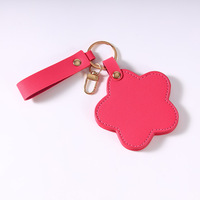Miroir de maquillage en PU haut de gamme personnalisé européen et américain avec fleur rotative, portable pour voyage, porte-clés.