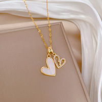 Collier tendance en acier inoxydable avec pendentif double cœur creux en zircone micro-sertie de cuivre pour femme