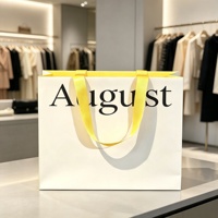 Sac shopping en papier blanc cassé de luxe avec logo personnalisé et poignées en ruban de satin jaune vif pour l'emballage de vêtements et d'accessoires