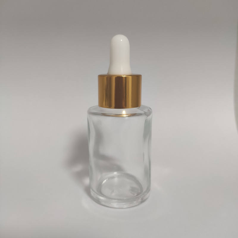 Clear bottle with gold dropper head