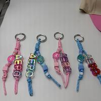 Porte-clés en cordon tressé fait main, perles lettres laser irisées, breloque cœur, accessoire de sac noué à la main Kawaii