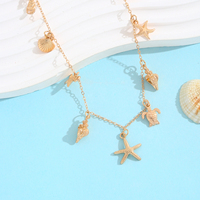 Collier chaîne en or avec 9 breloques marines : étoile de mer, tortue, dollar de sable, conque – Bijoux de plage tendance bohème pour femme