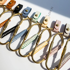 Cross-border PU <b>leather</b> brass carabiner <b>keychain</b>, simple retro pacifier stud key pendant, car <b>keychain</b> - Product Image 1