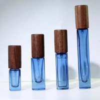 Vente en gros de flacons de parfum en verre noir et bleu de 3 ml, 5 ml et 10 ml, flacons de parfum portables avec bouchons en bois