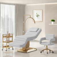 Lit de massage de luxe avec base dorée, commande au pied, 3 moteurs et lumière LED pour salon de beauté