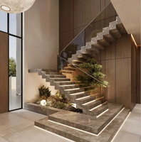 Escalier en marbre empilé lumineux avec garde-corps en verre et éclairage d'escalier chaleureux
