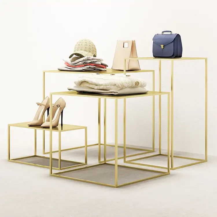 XINJI-Mesa de nido de diseño para tienda de moda, estante de ropa de ajuste dorado, mesa de exhibición de ropa