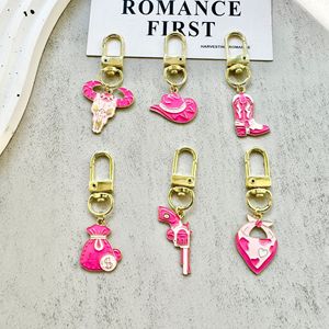 AM スイートクールピンク ウエスタンキーホルダー カウボーイ要素、雄牛の頭、ブーツ、マネーバッグのペンダント付き。 - Product Image 2
