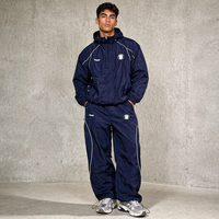 Ensemble de survêtement personnalisé en nylon respirant coupe-vent unisexe avec fermeture éclair, veste de sport brodée à capuche et pantalon pour homme