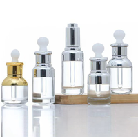 Flacon en verre cylindrique de luxe avec compte-gouttes épaissi électroplaqué pour l'emballage de parfums, d'huiles essentielles et de lotions