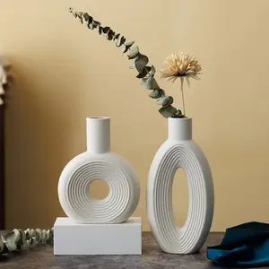 Precio de fábrica, venta al por mayor, jarrones nórdicos de mesa únicos creativos, jarrones de cerámica de flores decorativos modernos para decoración del hogar