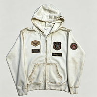 Sweat à capuche zippé effet vieilli, style streetwear épais, avec patchs et bords déchirés, blanc, pour homme, vente en gros par lot