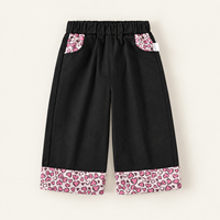 Celana Kulot Hitam untuk Anak Perempuan dengan Panel Saku Motif Leopard Pink dan Pita Kontras di Bagian Bawah untuk Koleksi Pakaian Anak Grosir dan Kustom