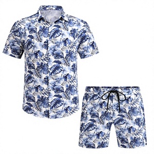 Camisa de manga corta con botones y cuello de solapa para hombre, con estampado tropical de hojas de palma en azul y blanco, conjunto de 2 piezas con pantalones cortos a juego, estilo hawaiano informal. - Product Image 1